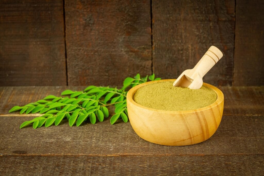 moringa, powder, leaves, moringa oleifera, super food, nature, healthy, vitamins, herbal, supplement, organic, wooden bowl, rustic, closeup